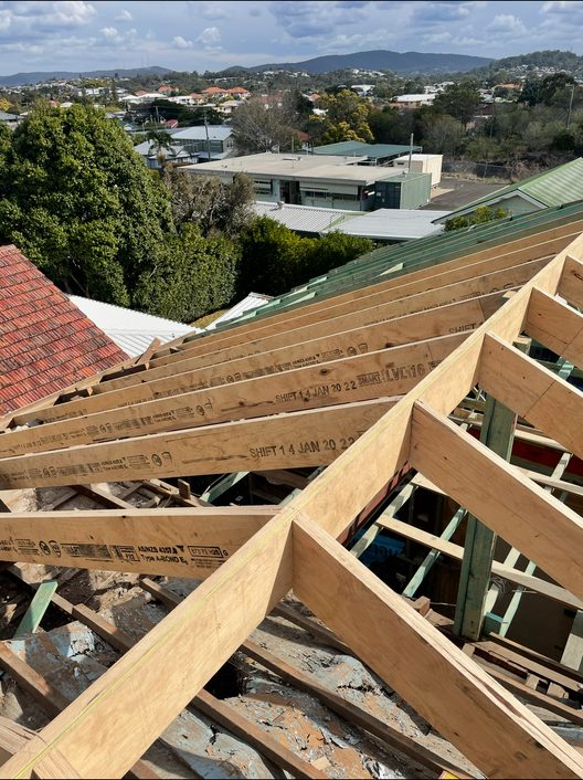 Roof framing in progress with new timber members over Brisbane rooftops